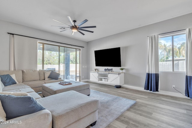 living room featuring ceiling fan and light wood-type flooring