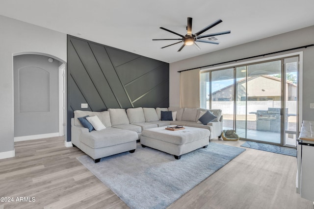 living room with ceiling fan and light hardwood / wood-style floors