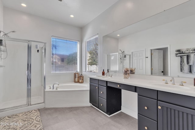 bathroom with tile patterned flooring, vanity, and separate shower and tub