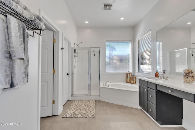 bathroom featuring tile patterned flooring, shower with separate bathtub, and vanity