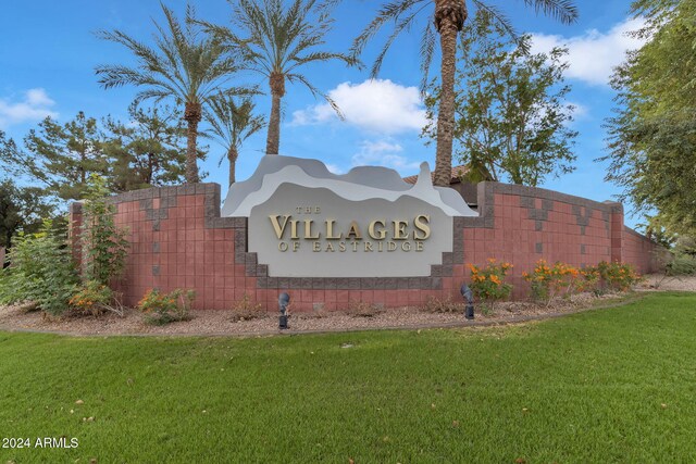 community sign featuring a lawn