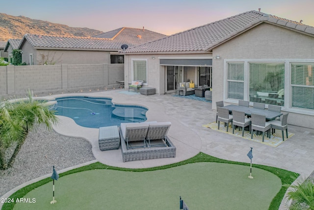 view of swimming pool with a patio, a fenced backyard, a mountain view, an outdoor hangout area, and a fenced in pool