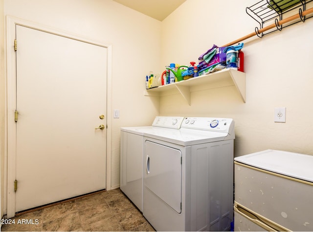clothes washing area featuring washing machine and clothes dryer and laundry area