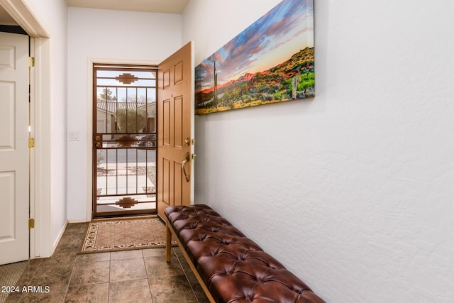 doorway with tile patterned floors