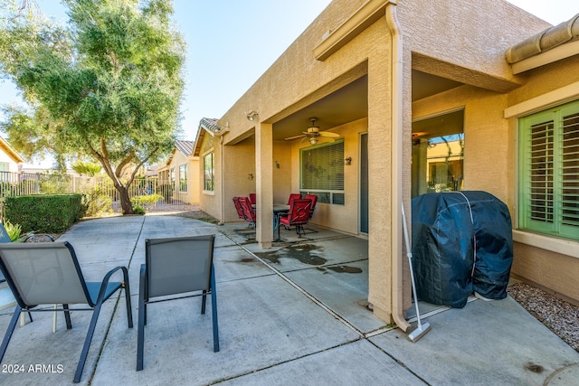 view of patio / terrace with fence, a grill, and ceiling fan