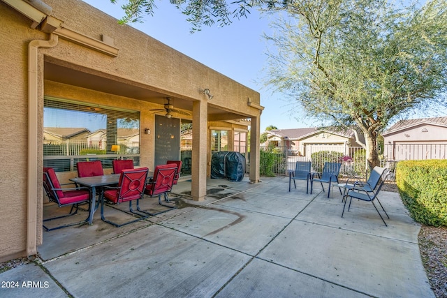 view of patio / terrace with area for grilling, fence, and ceiling fan