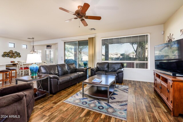 living area with a ceiling fan, dark wood-style flooring, and visible vents