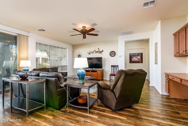 living area with visible vents, dark wood-style flooring, and a ceiling fan