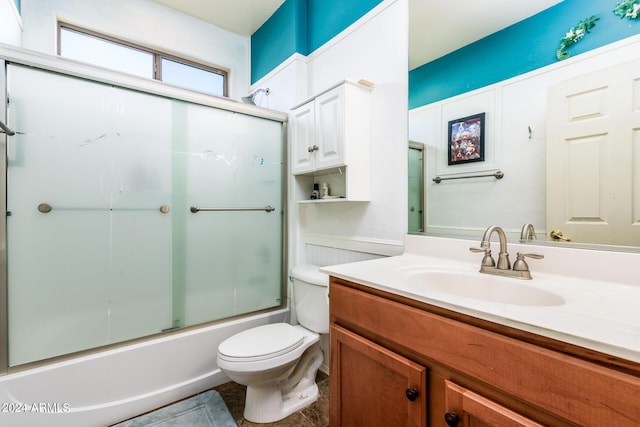 full bath featuring bath / shower combo with glass door, toilet, and vanity