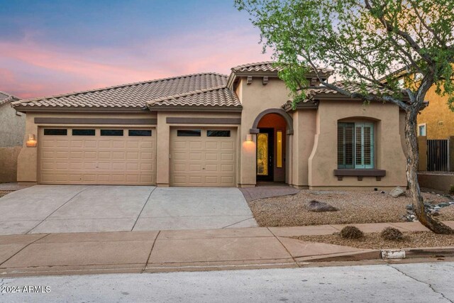 mediterranean / spanish-style house featuring a garage