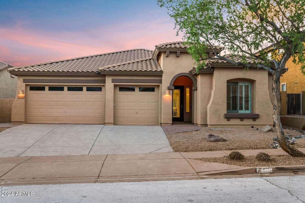 mediterranean / spanish-style house featuring a garage