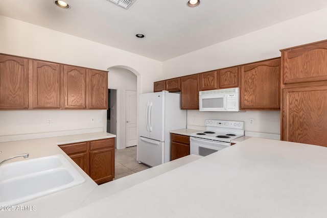 2732 E Tyson St, Chandler, AZ 85225 - kitchen with white appliances, a sink, light countertops, arched walkways, and recessed lighting