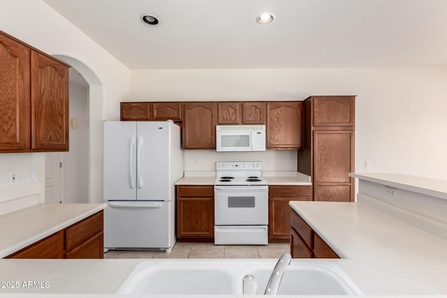 2732 E Tyson St, Chandler, AZ 85225 - kitchen featuring white appliances, a sink, brown cabinets, light countertops, and recessed lighting