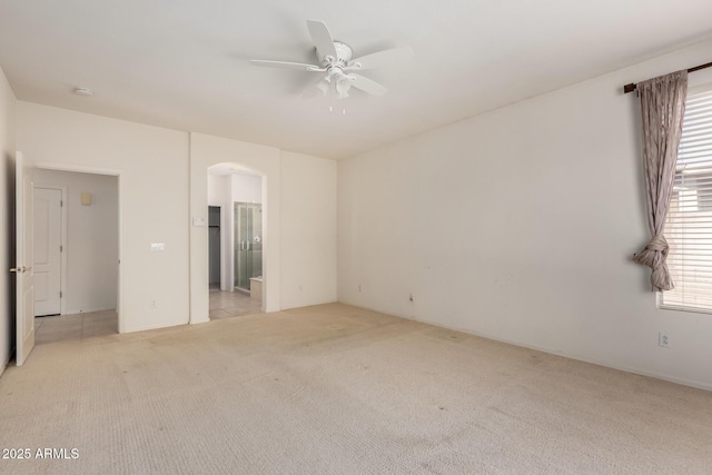 2732 E Tyson St, Chandler, AZ 85225 - unfurnished bedroom featuring light colored carpet, arched walkways, ensuite bathroom, and a ceiling fan