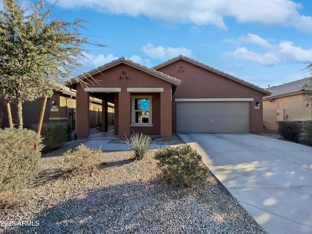 view of front of house featuring driveway, a garage, and stucco siding