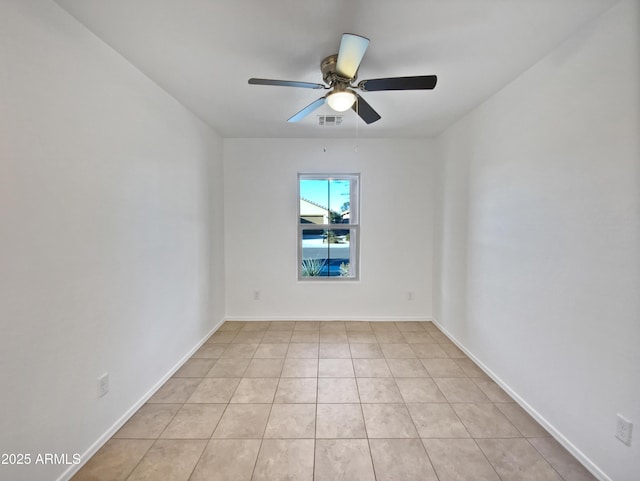 unfurnished room featuring ceiling fan, visible vents, baseboards, and light tile patterned flooring