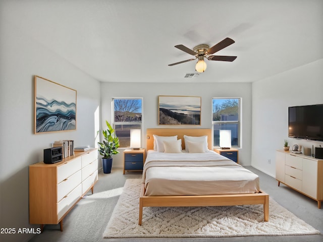 carpeted bedroom with visible vents and a ceiling fan