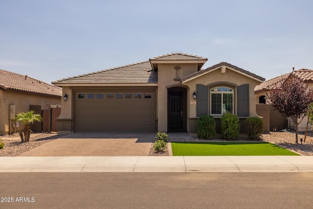 35193 N Agua Caliente, San Tan Valley, AZ 85144 - mediterranean / spanish-style house with decorative driveway, a garage, stucco siding, and a tile roof