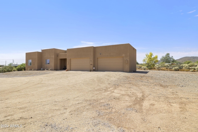 view of front of home featuring a mountain view and a garage