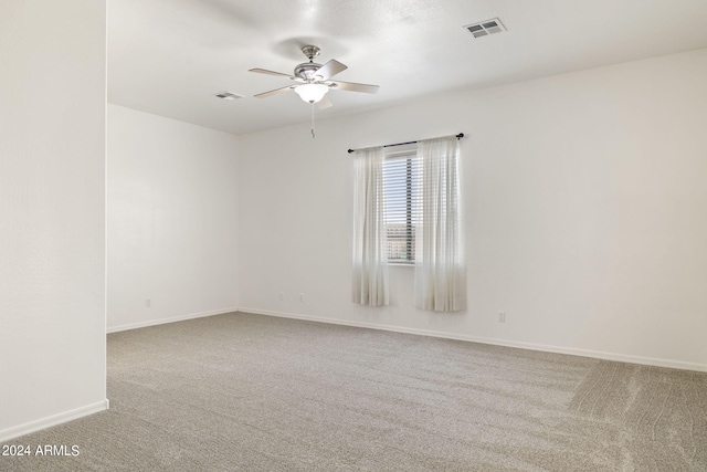 carpeted spare room with ceiling fan