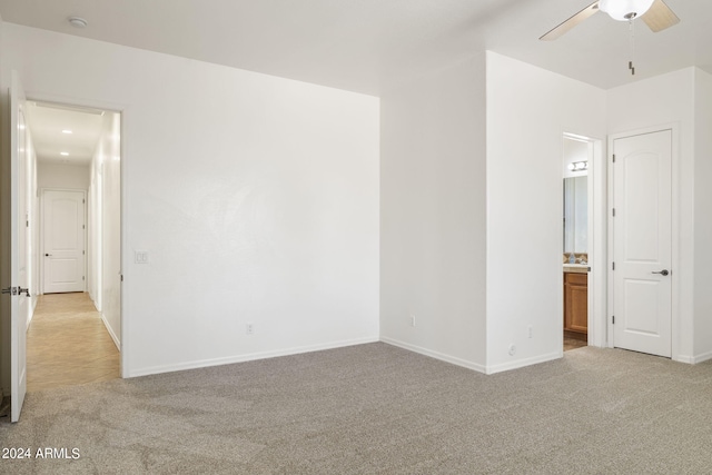 empty room featuring light colored carpet and ceiling fan