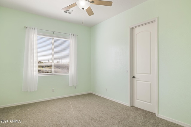 empty room with carpet flooring and ceiling fan