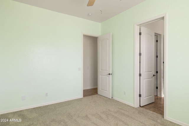 unfurnished bedroom with ceiling fan and light colored carpet