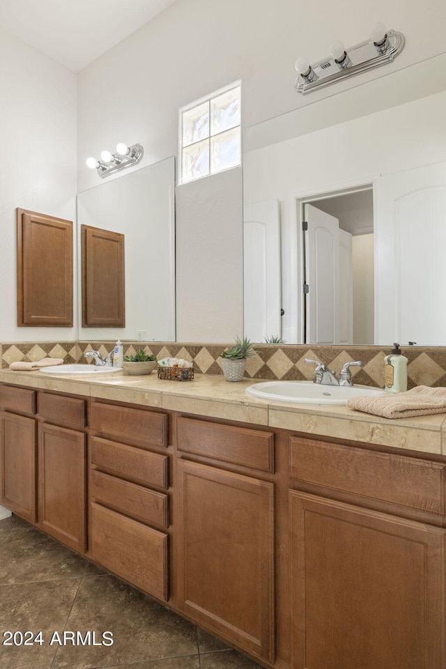 bathroom with vanity and tasteful backsplash