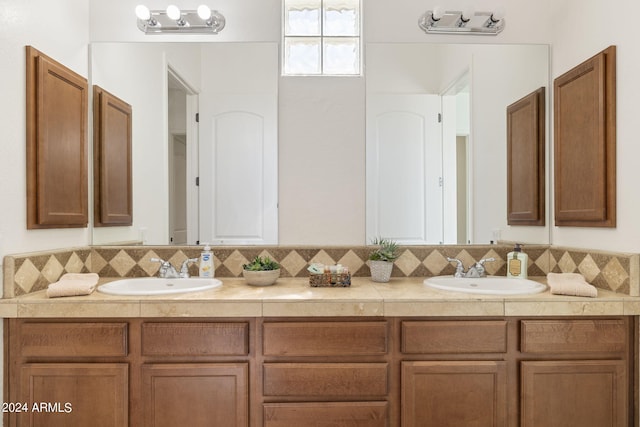 bathroom featuring vanity and tasteful backsplash