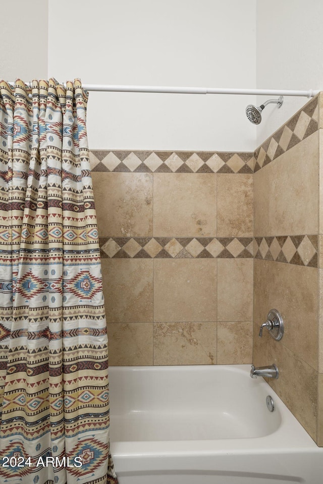 bathroom featuring shower / bathtub combination with curtain