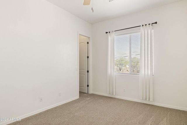 unfurnished room with ceiling fan and light colored carpet