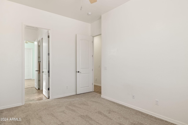 unfurnished bedroom featuring light carpet and ceiling fan