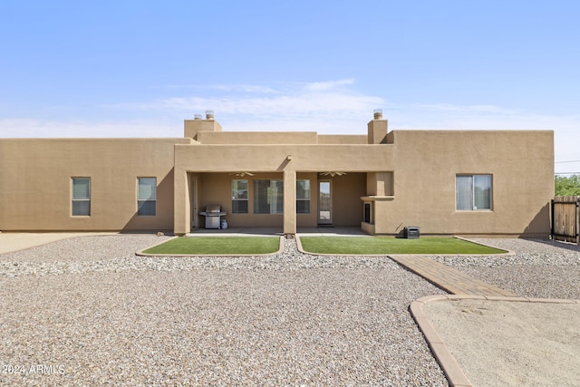 back of house with a patio area and ceiling fan