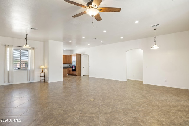 unfurnished living room featuring ceiling fan and light tile patterned flooring