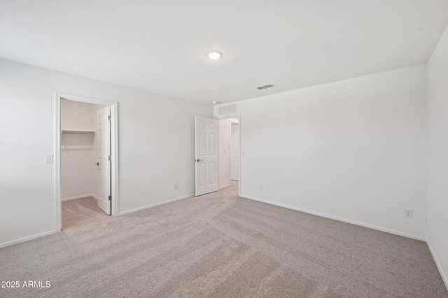 5535 S 240th Ln, Buckeye, AZ 85326 - unfurnished bedroom featuring light carpet, a walk in closet, and a closet