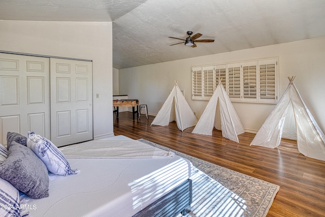 bedroom with ceiling fan, a closet, vaulted ceiling, and wood-type flooring