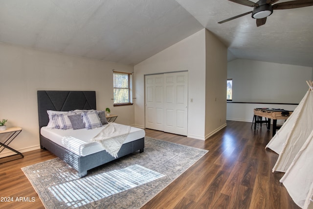 bedroom featuring ceiling fan, a closet, dark hardwood / wood-style flooring, and lofted ceiling