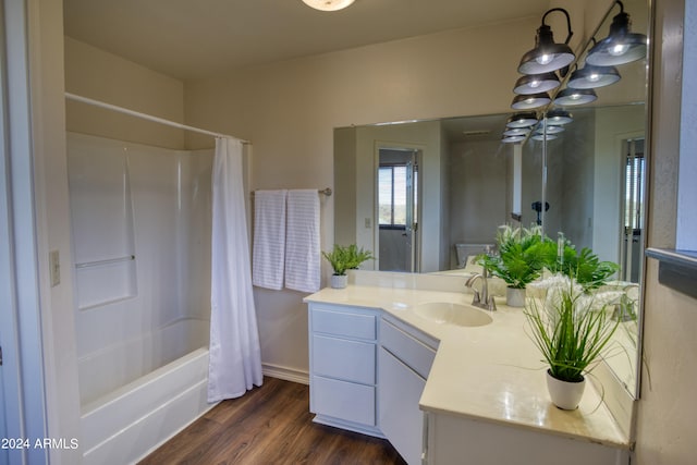 bathroom with shower / bath combo, a chandelier, hardwood / wood-style flooring, and vanity