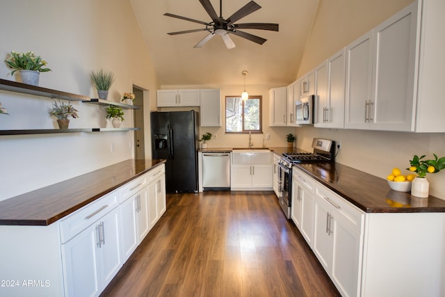 kitchen featuring lofted ceiling, stainless steel appliances, white cabinets, sink, and dark hardwood / wood-style flooring