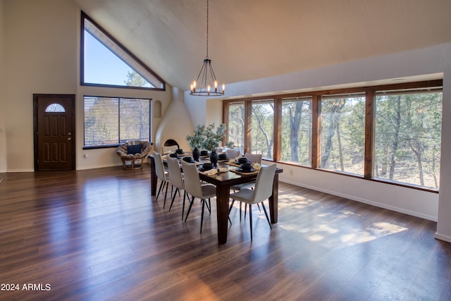 dining room featuring dark hardwood / wood-style floors, high vaulted ceiling, and a chandelier