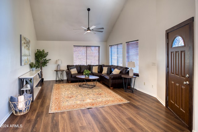 living room with plenty of natural light, dark hardwood / wood-style floors, and high vaulted ceiling