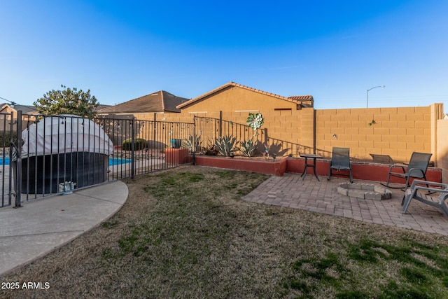 view of yard featuring a fenced in pool and a patio area