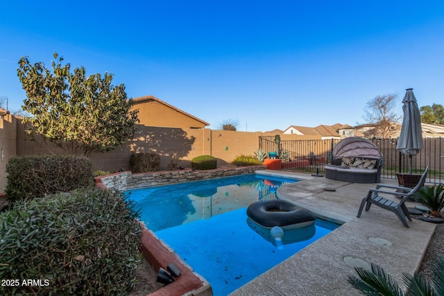 view of swimming pool featuring a patio and an outdoor fire pit