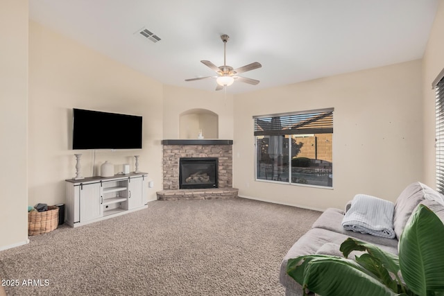 living room with ceiling fan, carpet flooring, and a fireplace