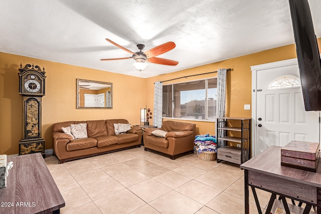 tiled living room with ceiling fan and a textured ceiling