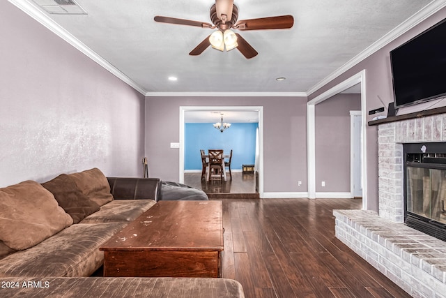 unfurnished living room with ornamental molding, ceiling fan with notable chandelier, a fireplace, and dark hardwood / wood-style flooring