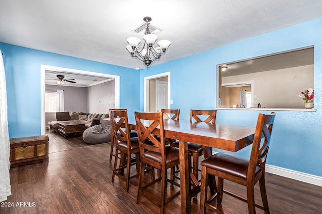 dining room featuring dark wood-type flooring and ceiling fan with notable chandelier