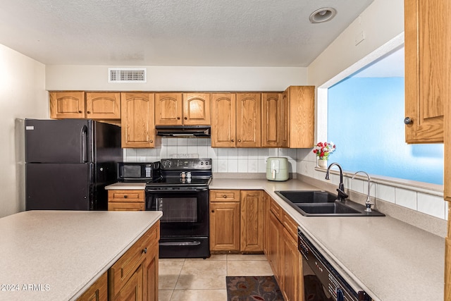 kitchen with black appliances, sink, backsplash, a textured ceiling, and light tile patterned floors