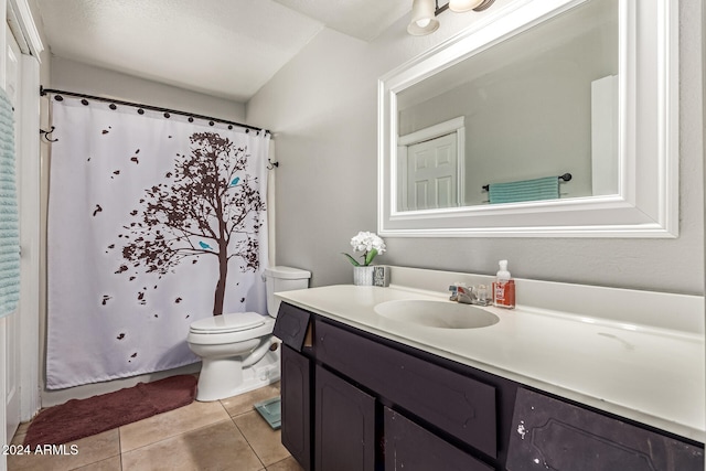 bathroom with toilet, vanity, and tile patterned floors