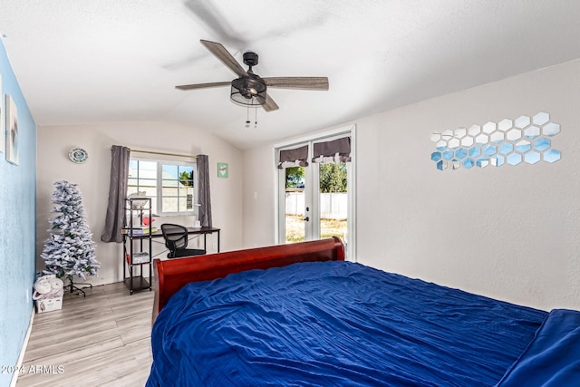 bedroom with ceiling fan, lofted ceiling, multiple windows, and light wood-type flooring